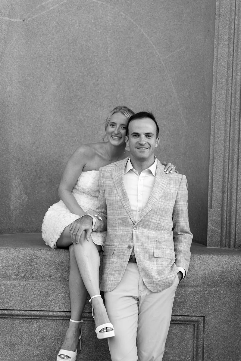 Ellie and Marcus on a granite ledge, in black and white