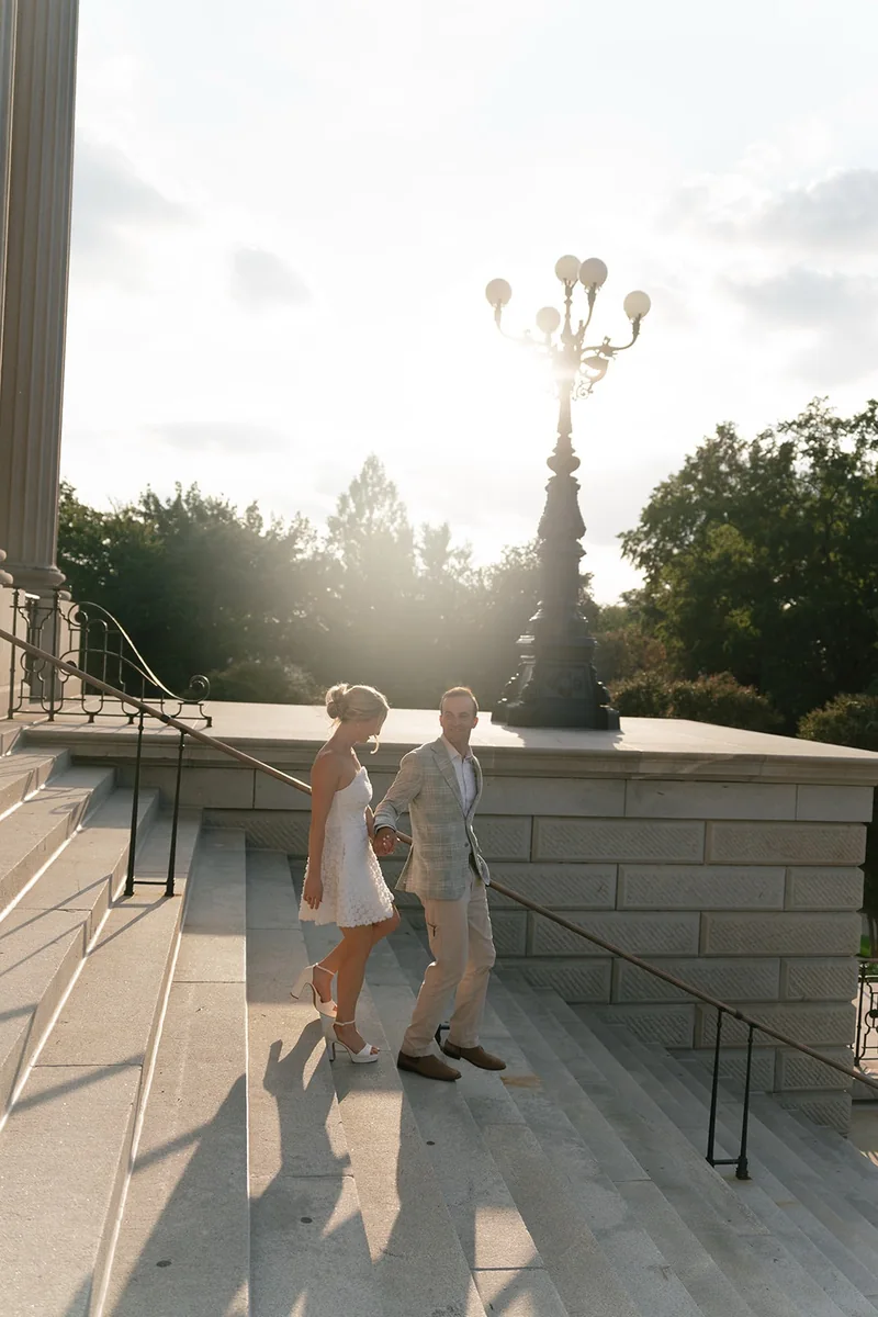 Ellie stepping down the State House steps to Marcus, under the lamp post in evening light