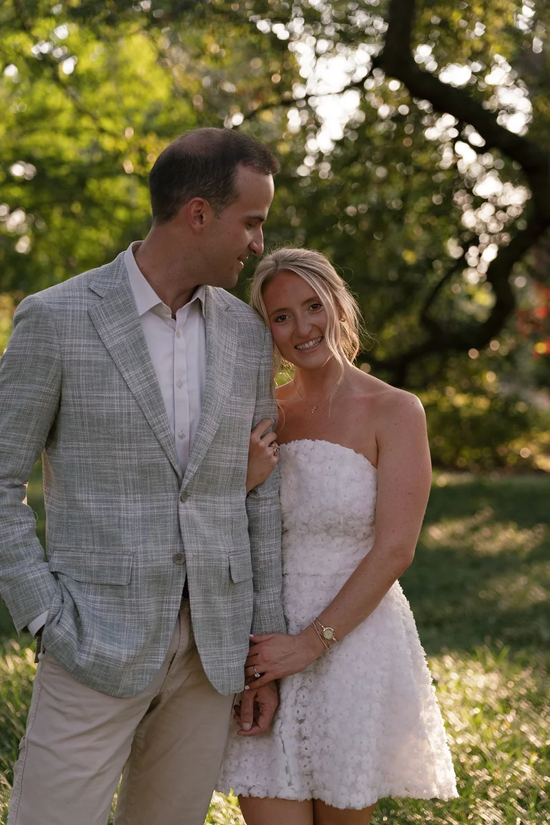 Marcus looking at Ellie under the trees